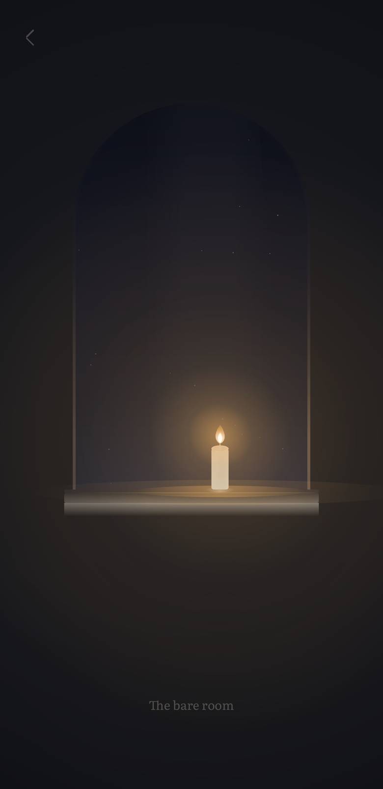 The prayer room at night: one candle lit on the sill beneath the arch
